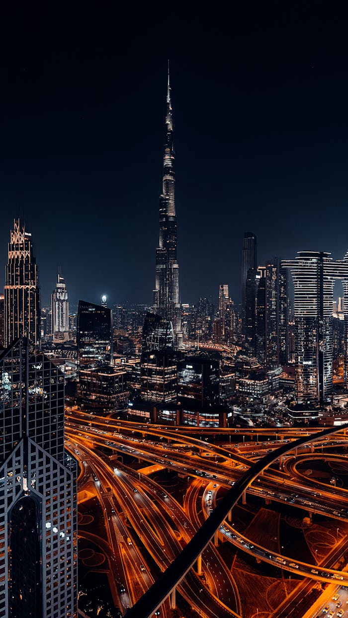 A breathtaking nighttime view of the illuminated Dubai skyline featuring the iconic Burj Khalifa.